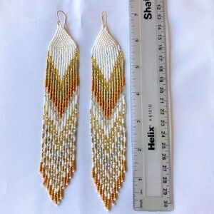 Women’s dangling beaded earrings in white, gold, copper, and silver beads